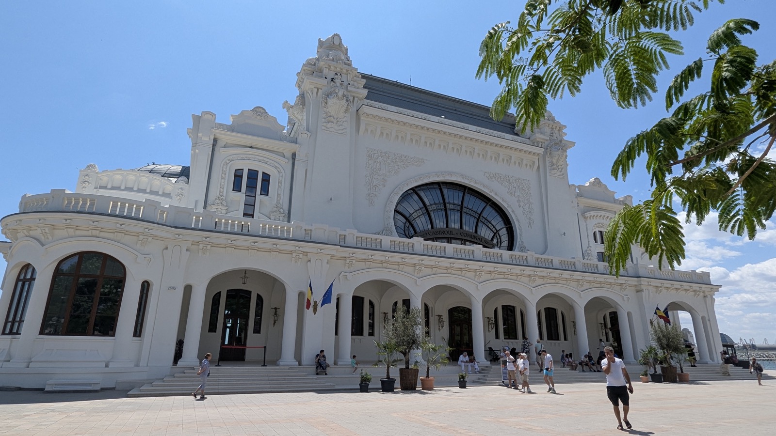 Fațada principală a Cazinoului după restaurare, cu fereastra mare în arc, arcadele de la parter și esplanada din față